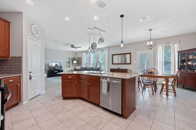 kitchen featuring stainless steel dishwasher, a sink, plenty of natural light, light tile patterned floors, and recessed lighting