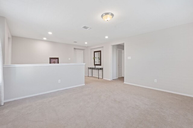 unfurnished room featuring light colored carpet, baseboards, and recessed lighting