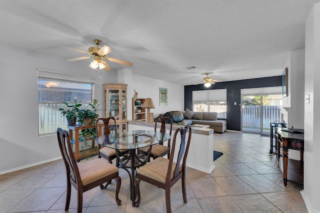 302 Debora Dr, Georgetown, TX 78628 - tiled dining area featuring ceiling fan, a textured ceiling, and baseboards