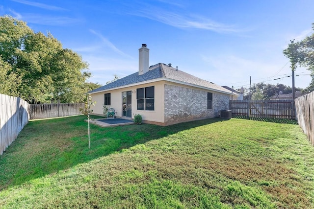 302 Debora Dr, Georgetown, TX 78628 - back of house with cooling unit, a chimney, and brick siding