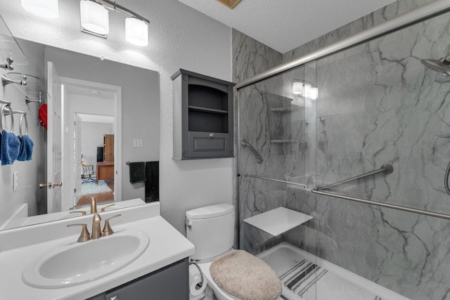 302 Debora Dr, Georgetown, TX 78628 - full bath featuring a marble finish shower, vanity, a textured ceiling, and toilet