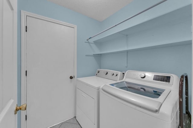 302 Debora Dr, Georgetown, TX 78628 - laundry area featuring independent washer and dryer, a textured ceiling, and light tile patterned floors