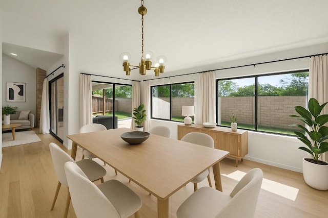 1046 Verbena Dr Unit 1474, Austin, TX 78750 - dining room featuring light wood finished floors, healthy amount of natural light, a chandelier, vaulted ceiling, and baseboards