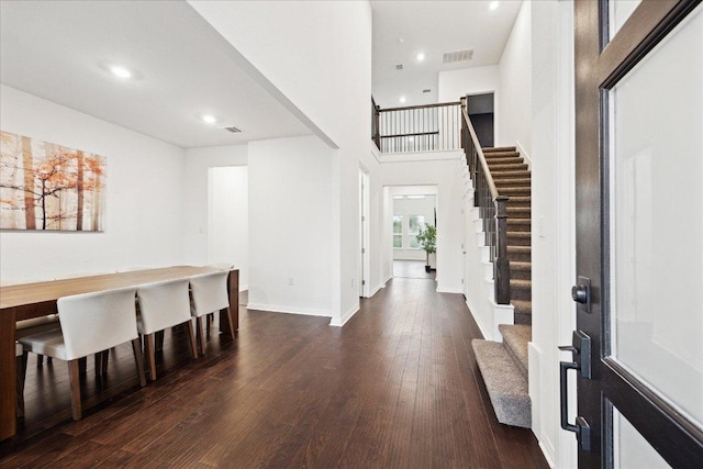 208 Carolina Jasmine Dr, San Marcos, TX 78666 - foyer entrance featuring stairs, dark wood-style flooring, recessed lighting, a towering ceiling, and baseboards