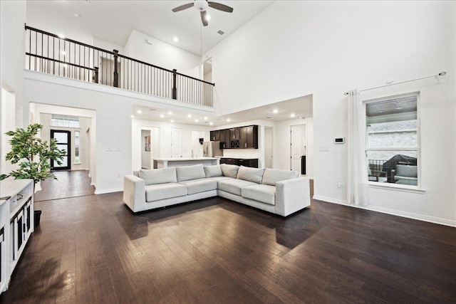 208 Carolina Jasmine Dr, San Marcos, TX 78666 - living area featuring dark wood-type flooring, ceiling fan, a high ceiling, baseboards, and recessed lighting