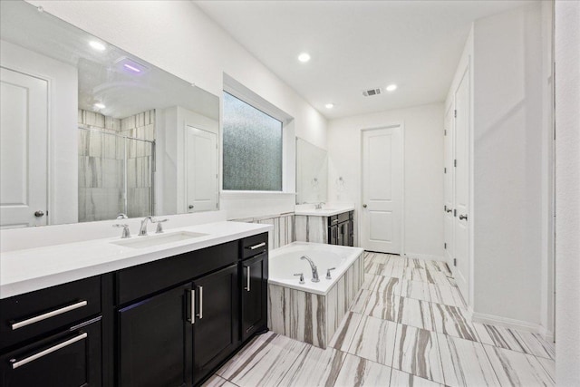 208 Carolina Jasmine Dr, San Marcos, TX 78666 - full bath with two vanities, a garden tub, a shower stall, and recessed lighting