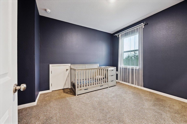 208 Carolina Jasmine Dr, San Marcos, TX 78666 - unfurnished bedroom with carpet flooring, a crib, a textured wall, and baseboards