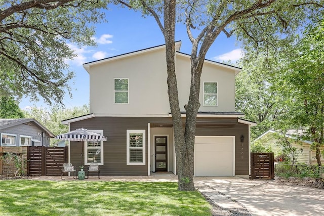 1809 Pasadena Dr, Austin, TX 78757 - view of front of house featuring a garage, concrete driveway, and stucco siding