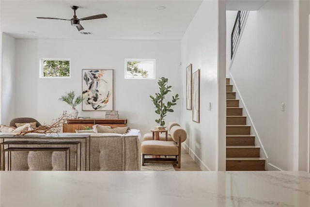 1809 Pasadena Dr, Austin, TX 78757 - living area with stairway, healthy amount of natural light, a ceiling fan, and baseboards