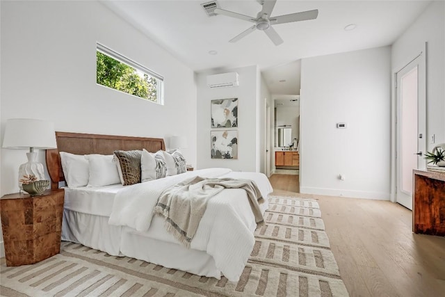 1809 Pasadena Dr, Austin, TX 78757 - bedroom featuring light wood-style flooring, a wall unit AC, baseboards, and ensuite bathroom