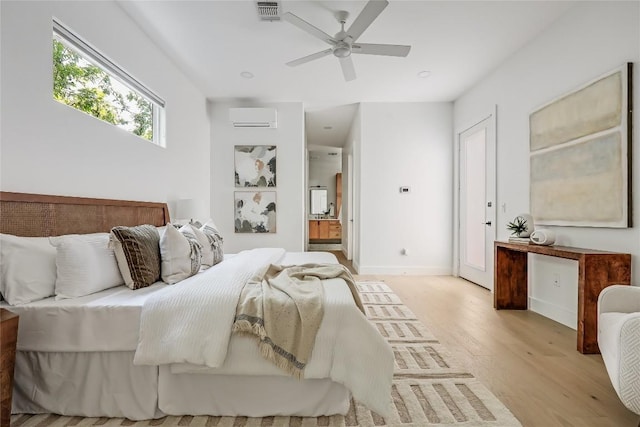 1809 Pasadena Dr, Austin, TX 78757 - bedroom with light wood-style floors, connected bathroom, a wall unit AC, and ceiling fan