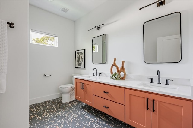 1809 Pasadena Dr, Austin, TX 78757 - bathroom featuring double vanity, toilet, baseboards, and tile patterned floors