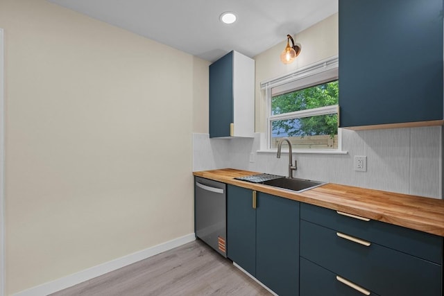 8507 Parkfield Dr, Austin, TX 78758 - kitchen featuring butcher block counters, dishwasher, a sink, light wood finished floors, and blue cabinetry