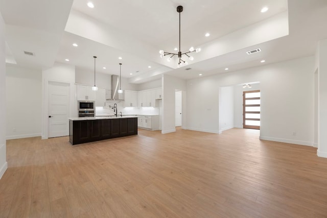 310 Apache Tears, Horseshoe Bay, TX 78657 - kitchen with wall chimney range hood, recessed lighting, a chandelier, light countertops, and open floor plan