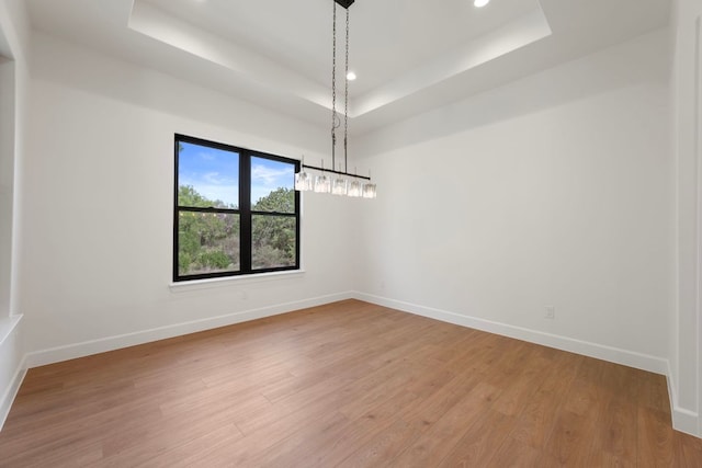 310 Apache Tears, Horseshoe Bay, TX 78657 - unfurnished room with a raised ceiling, baseboards, light wood-style flooring, and recessed lighting