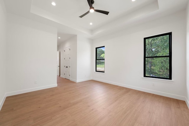 310 Apache Tears, Horseshoe Bay, TX 78657 - empty room featuring a tray ceiling, light wood-style floors, recessed lighting, and a ceiling fan