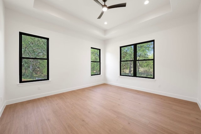 310 Apache Tears, Horseshoe Bay, TX 78657 - unfurnished room with a raised ceiling, a ceiling fan, light wood-type flooring, baseboards, and recessed lighting