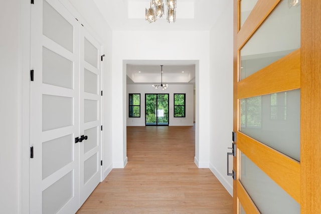 310 Apache Tears, Horseshoe Bay, TX 78657 - hall with a chandelier, light wood-style flooring, and baseboards