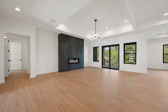 310 Apache Tears, Horseshoe Bay, TX 78657 - unfurnished living room featuring light wood-type flooring, a chandelier, healthy amount of natural light, baseboards, and recessed lighting