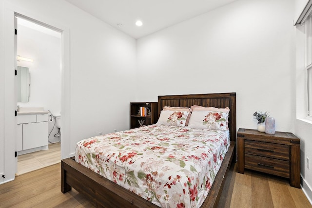 3417 Prairie Heights Dr, Leander, TX 78641 - bedroom featuring wood finished floors, recessed lighting, baseboards, and ensuite bathroom