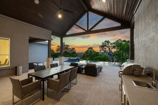3417 Prairie Heights Dr, Leander, TX 78641 - patio terrace at dusk with exterior kitchen, a sink, outdoor dining area, and a pool with connected hot tub