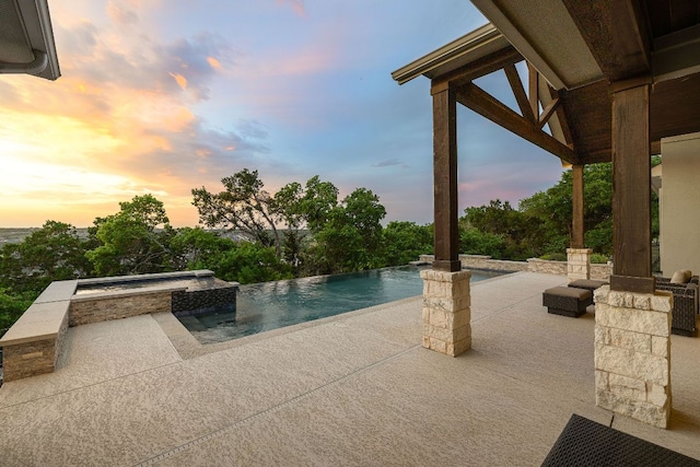 3417 Prairie Heights Dr, Leander, TX 78641 - pool at dusk featuring a patio area and a pool with connected hot tub