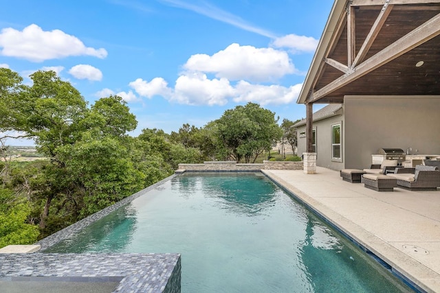3417 Prairie Heights Dr, Leander, TX 78641 - view of pool featuring exterior kitchen, a patio, an infinity pool, and an outdoor hangout area