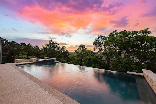 3417 Prairie Heights Dr, Leander, TX 78641 - pool at dusk featuring a pool with connected hot tub