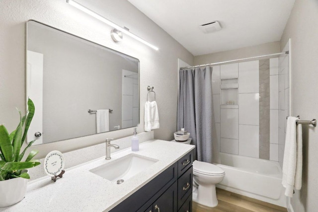 302 Martin Luther King St, Georgetown, TX 78626 - bathroom featuring vanity, toilet, shower / bath combo, and wood finished floors
