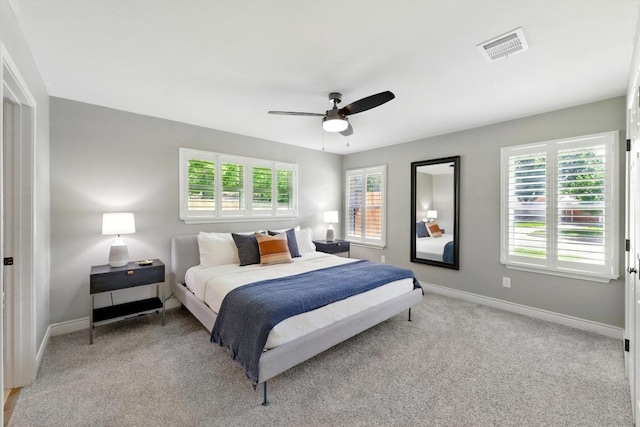 701 Nixon St, Lockhart, TX 78644 - bedroom with light carpet, baseboards, and a ceiling fan