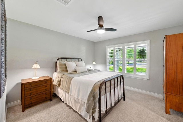 701 Nixon St, Lockhart, TX 78644 - bedroom with light carpet, baseboards, and a ceiling fan