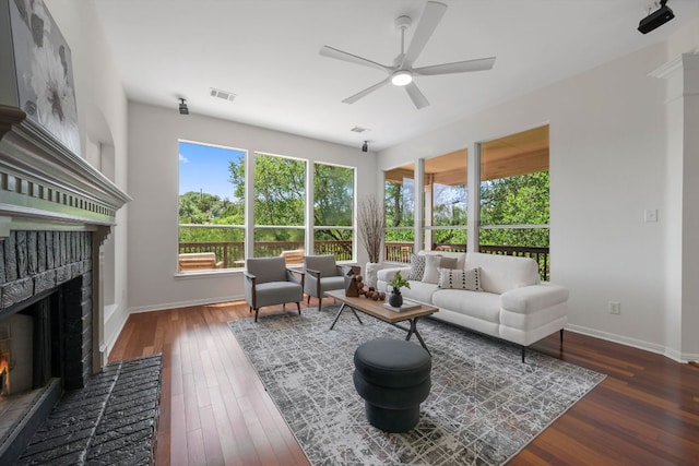 5804 Gentle Breeze Ter, Austin, TX 78731 - living area with a fireplace, a ceiling fan, wood finished floors, and baseboards