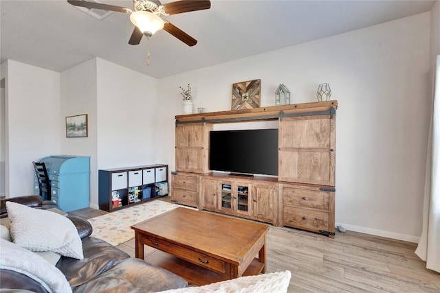 131 Mount Ellen St, Hutto, TX 78634 - living area with light wood finished floors, baseboards, and ceiling fan