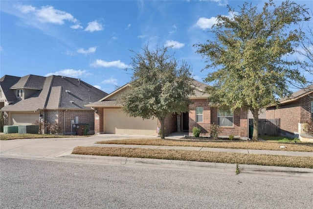 131 Mount Ellen St, Hutto, TX 78634 - view of front of home with brick siding, concrete driveway, an attached garage, central AC, and fence
