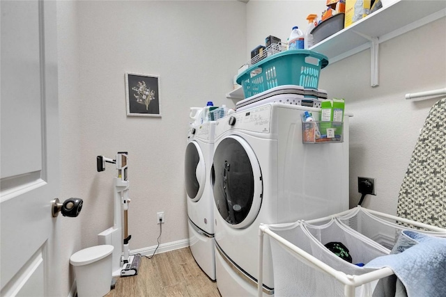 131 Mount Ellen St, Hutto, TX 78634 - laundry room featuring wood finished floors, separate washer and dryer, and baseboards