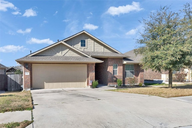 131 Mount Ellen St, Hutto, TX 78634 - view of front of house with roof with shingles, a garage, driveway, and brick siding