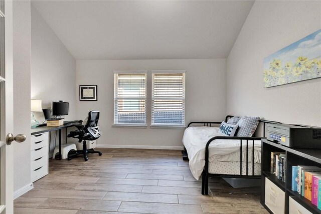 131 Mount Ellen St, Hutto, TX 78634 - bedroom featuring vaulted ceiling, light wood finished floors, a desk, and baseboards