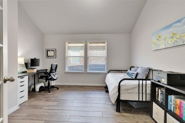 131 Mount Ellen St, Hutto, TX 78634 - bedroom with vaulted ceiling, light wood finished floors, a desk, and baseboards