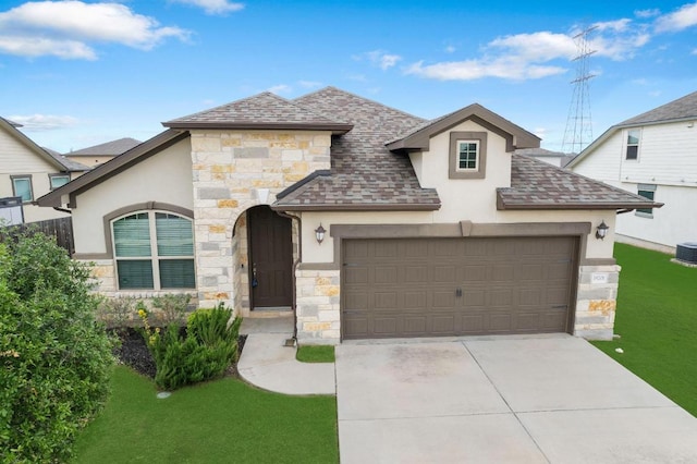 19201 Quebrada Dr, Pflugerville, TX 78660 - view of front of house with stone siding, stucco siding, and an attached garage