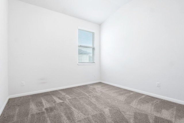 19201 Quebrada Dr, Pflugerville, TX 78660 - carpeted empty room with vaulted ceiling and baseboards