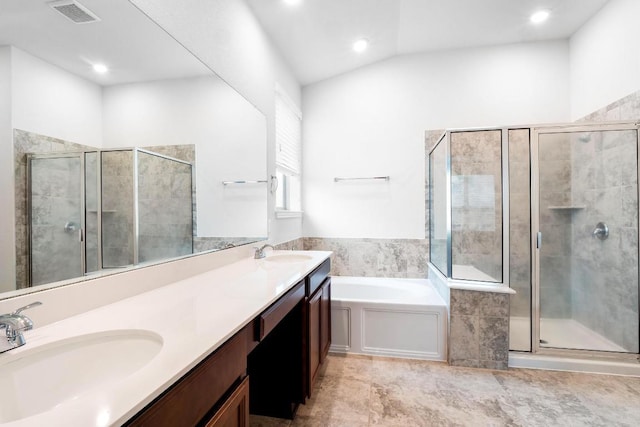 19201 Quebrada Dr, Pflugerville, TX 78660 - full bath featuring a shower stall, double vanity, a bath, recessed lighting, and vaulted ceiling