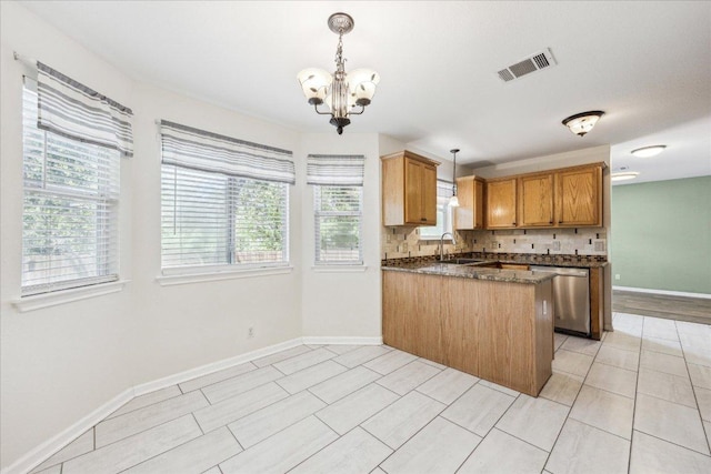 kitchen with a peninsula, a chandelier, stainless steel dishwasher, a sink, and decorative backsplash