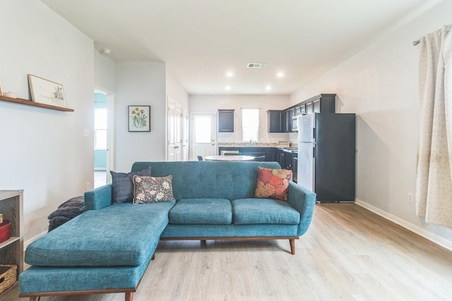 533 Peony Ct, Jarrell, TX 76537 - living area featuring light wood-style floors, baseboards, and recessed lighting
