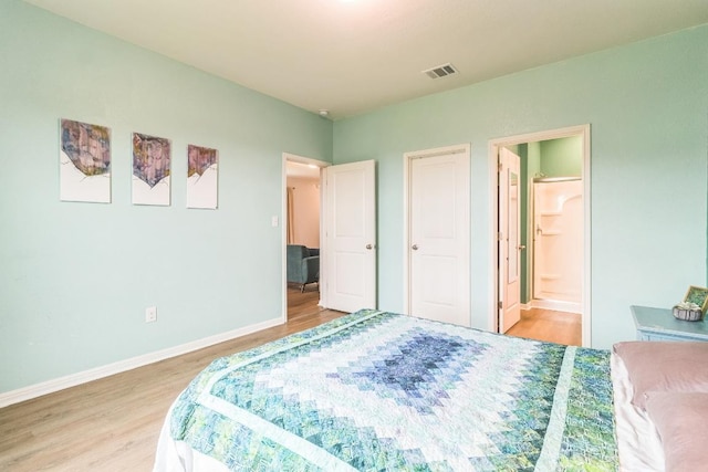533 Peony Ct, Jarrell, TX 76537 - bedroom with light wood-style flooring, baseboards, and ensuite bathroom