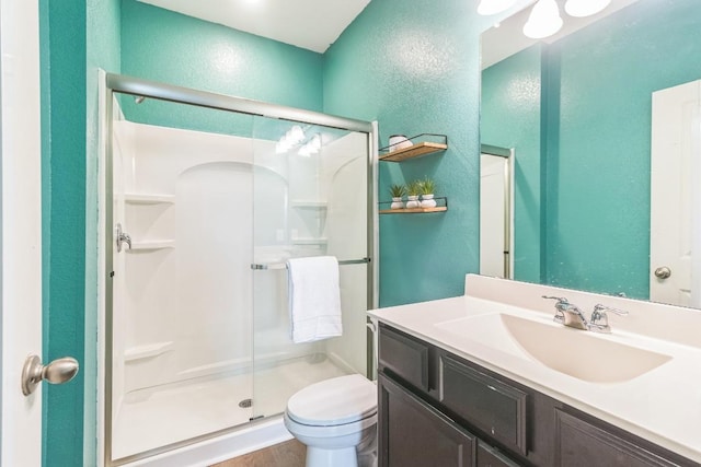 533 Peony Ct, Jarrell, TX 76537 - bathroom featuring a stall shower, a textured wall, toilet, vanity, and wood finished floors