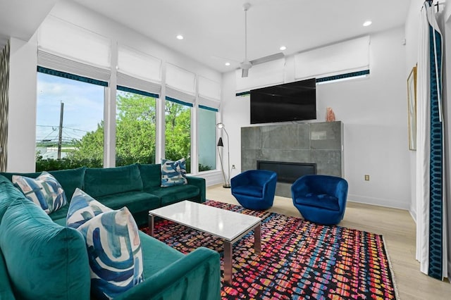 2002 E 8th St, Austin, TX 78702 - living area with a tile fireplace, wood finished floors, recessed lighting, and baseboards