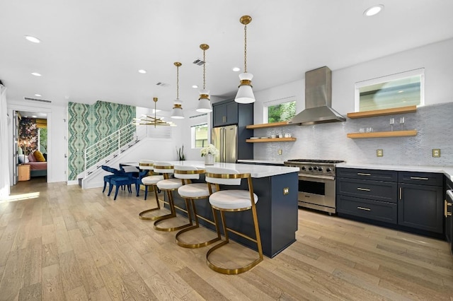 2002 E 8th St, Austin, TX 78702 - kitchen featuring appliances with stainless steel finishes, island exhaust hood, open shelves, light wood finished floors, and recessed lighting