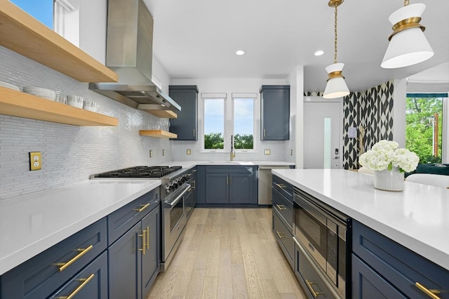 2002 E 8th St, Austin, TX 78702 - kitchen with wall chimney range hood, appliances with stainless steel finishes, open shelves, a sink, and light countertops