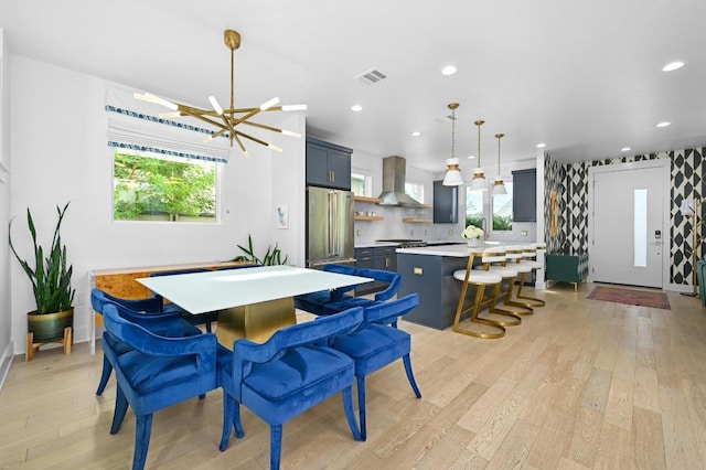 2002 E 8th St, Austin, TX 78702 - dining space with light wood-style flooring, healthy amount of natural light, a chandelier, recessed lighting, and baseboards