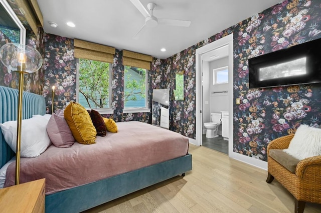2002 E 8th St, Austin, TX 78702 - bedroom with wallpapered walls, wood finished floors, baseboards, ensuite bathroom, and recessed lighting